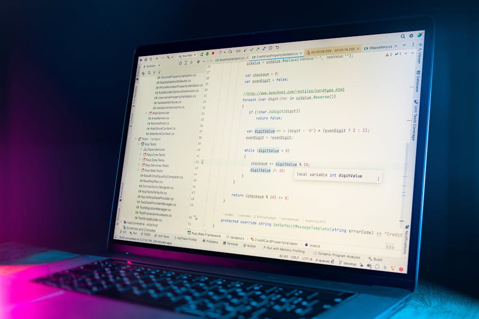 Close-up view of a computer screen displaying a code editor with multicolored lines of programming code on a dark background. The code consists of various syntax elements such as tags, variables, and